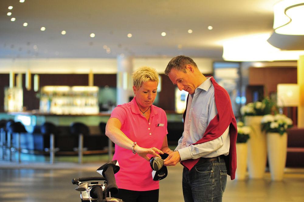 Hotel Neptun Rostock Exterior photo A saleswoman helping a customer